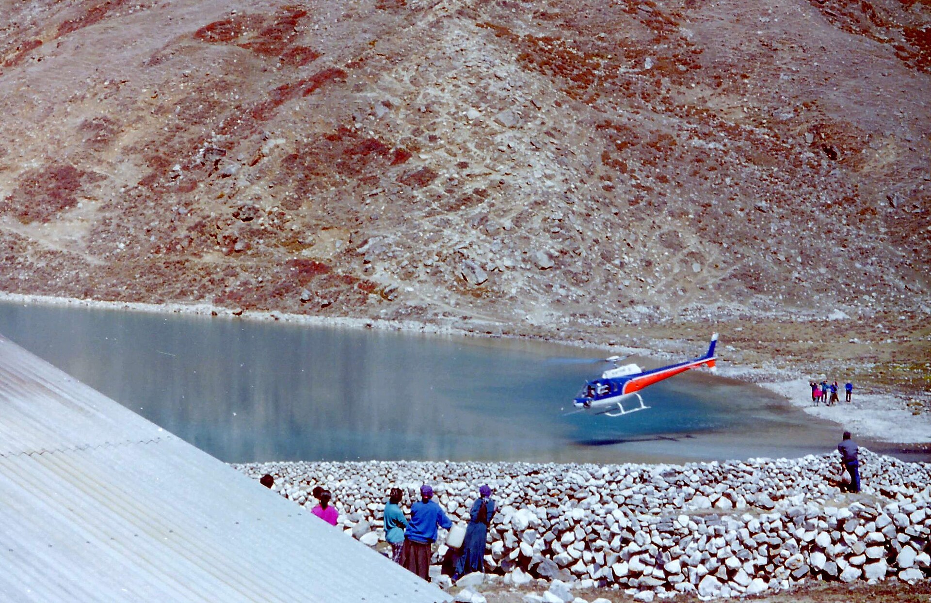 A single-engine charter helicopter parked at Gokyo, high in the Khumbu.